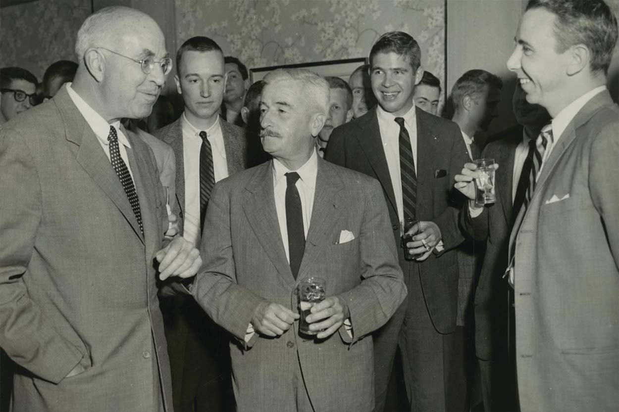 author William Faulkner and a group conversing