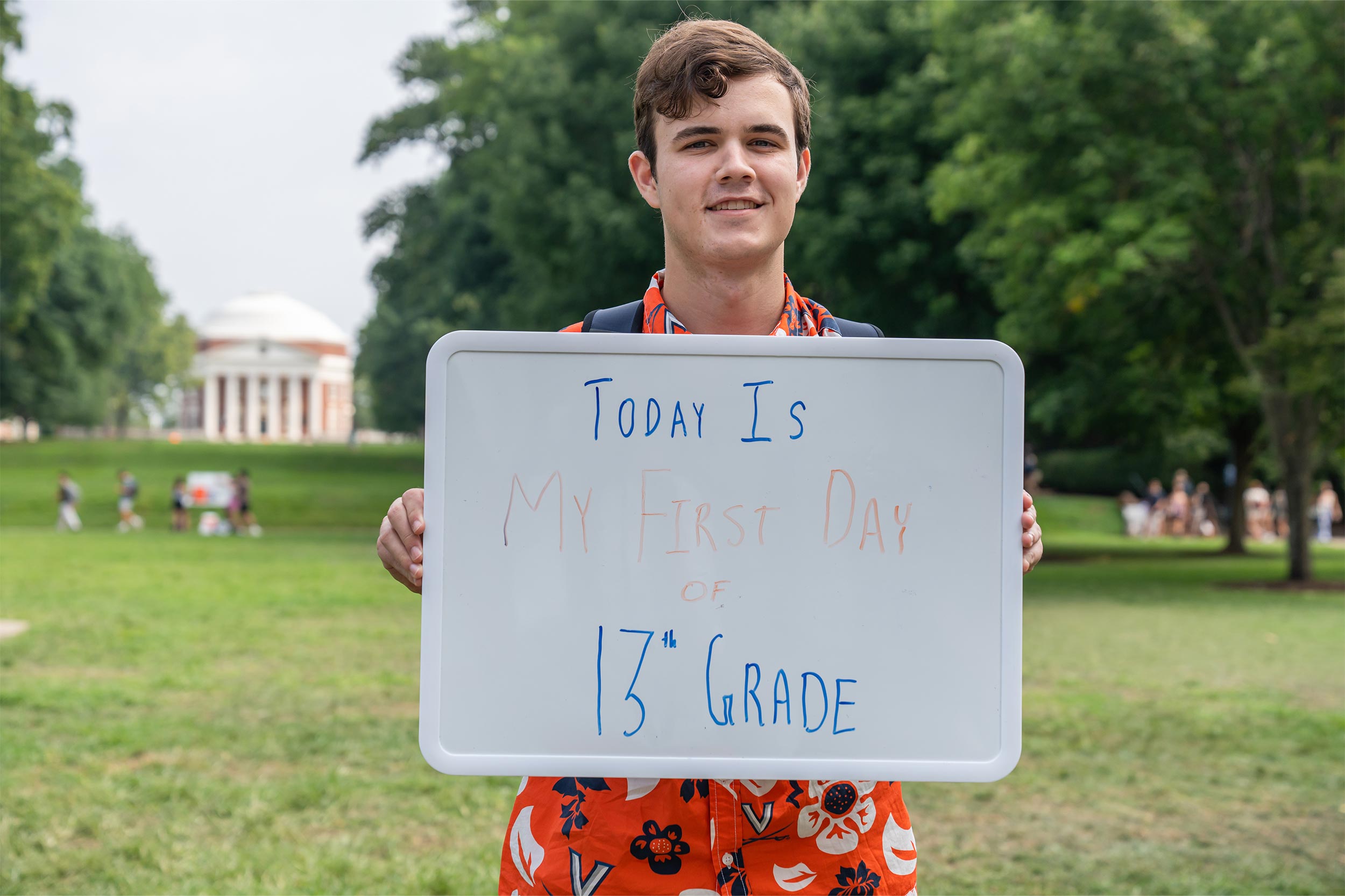 student posing with sign