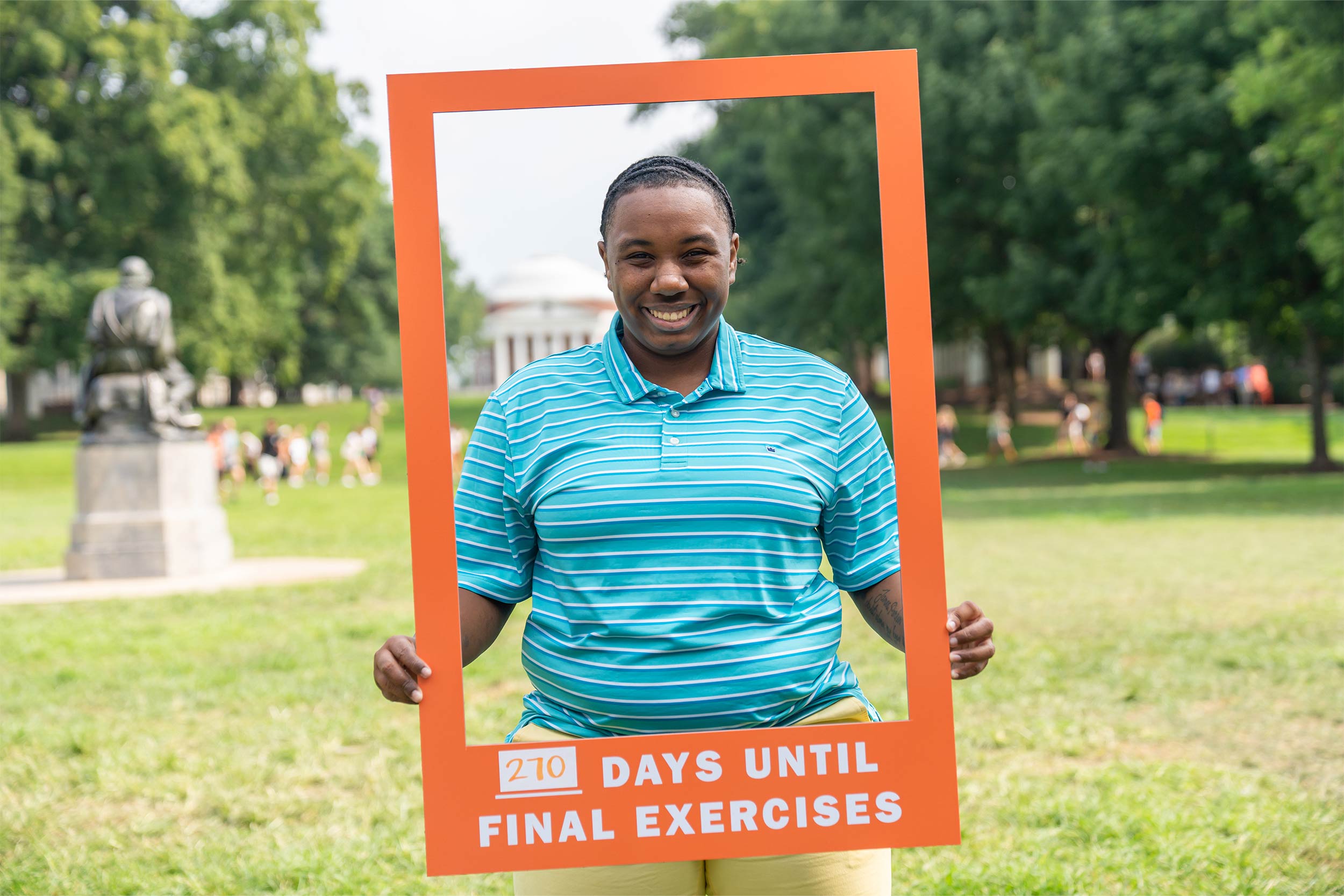 Student poses with sign