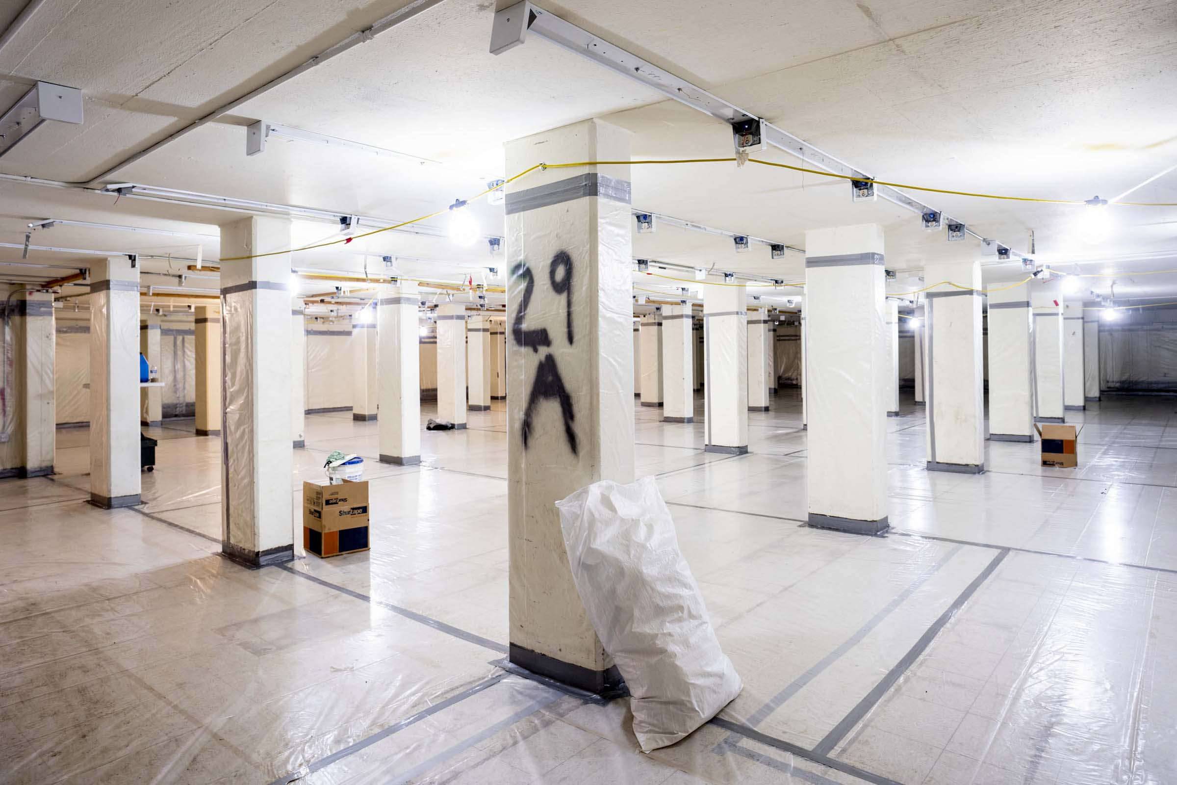 Plastic laid on the floor and plastic wrapped around every column