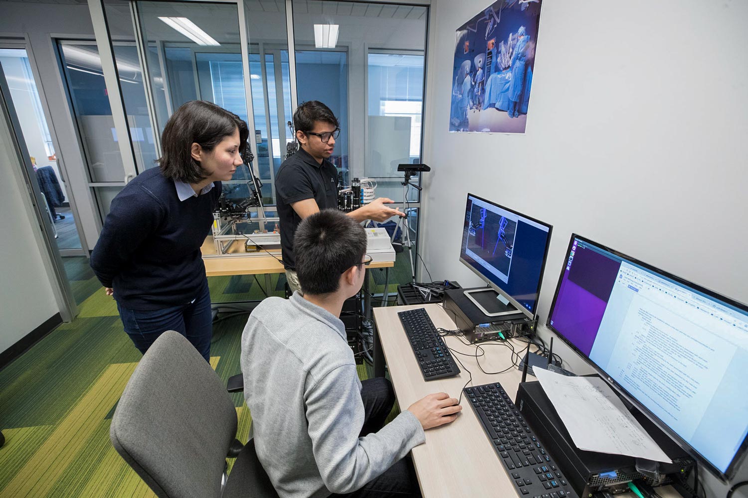 Alemzadeh works with  Samin Yaser, rear, and Yonming Qin on a computer